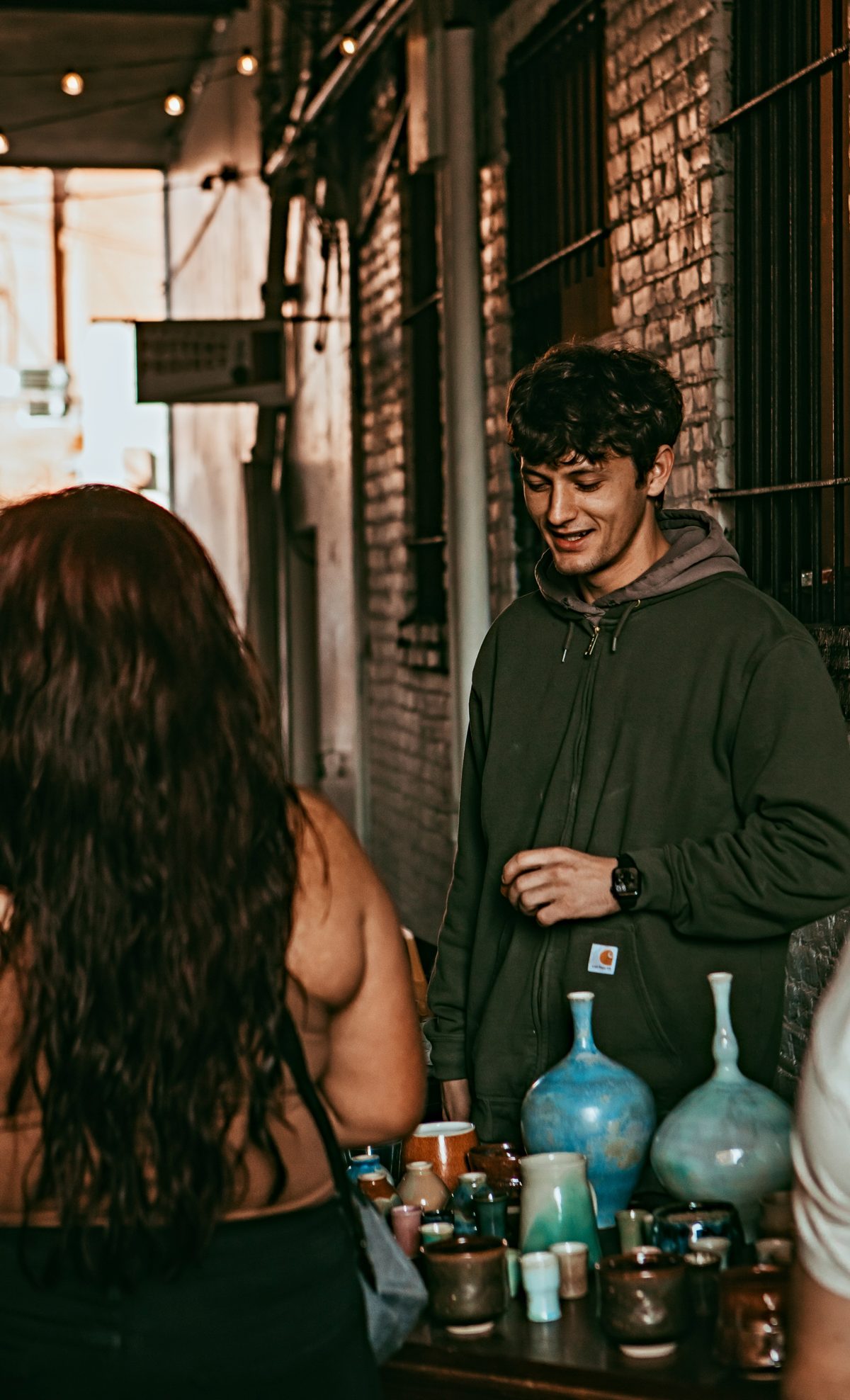 Artists and visitors chatting over pottery at the festival