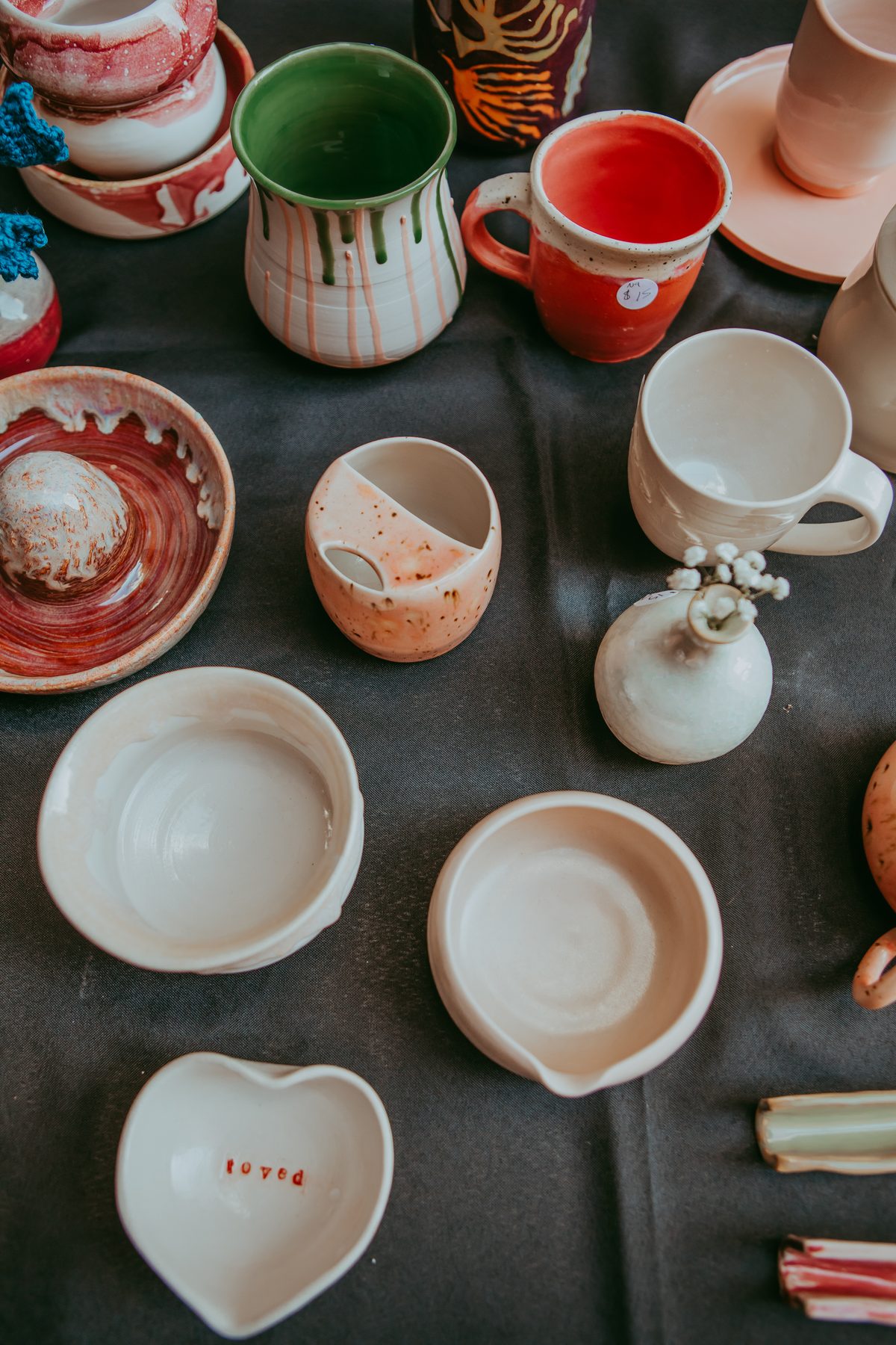 Colorful handmade pottery pieces displayed on a table